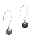 Close-up of glass and brass hexagon earrings
