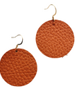 Grian leather earrings in burnt orange – circular lightweight earrings with gold hooks photographed on a plain white background