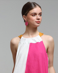 Model wearing Grian leather earrings in hot pink – handmade in Ireland