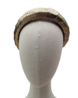 Gold textured leather-look padded headband displayed on a neutral mannequin head against a white background
