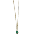 Close-up of brass and glass teardrop pendant