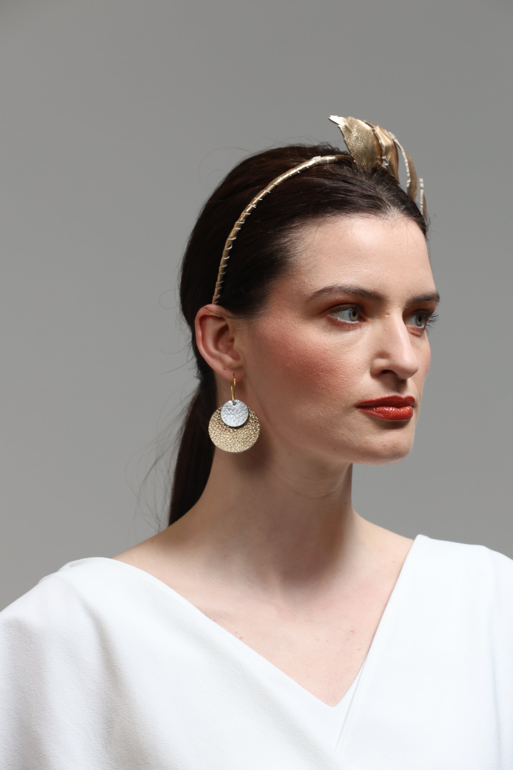 Grian agus Gealach leather earrings in white and gold on model