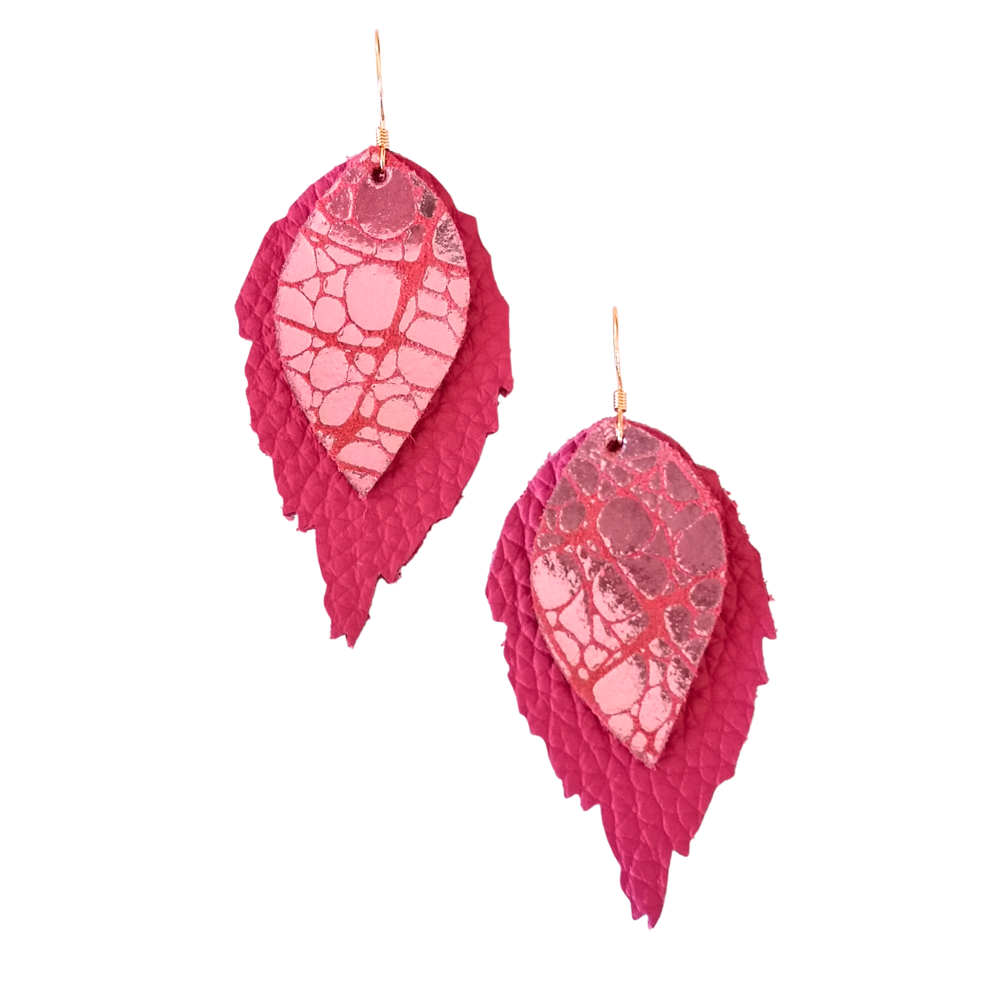 Statement earrings in vibrant pink with a glossy patterned top layer and textured leather base, crafted from Italian leather in a bold, layered leaf shape