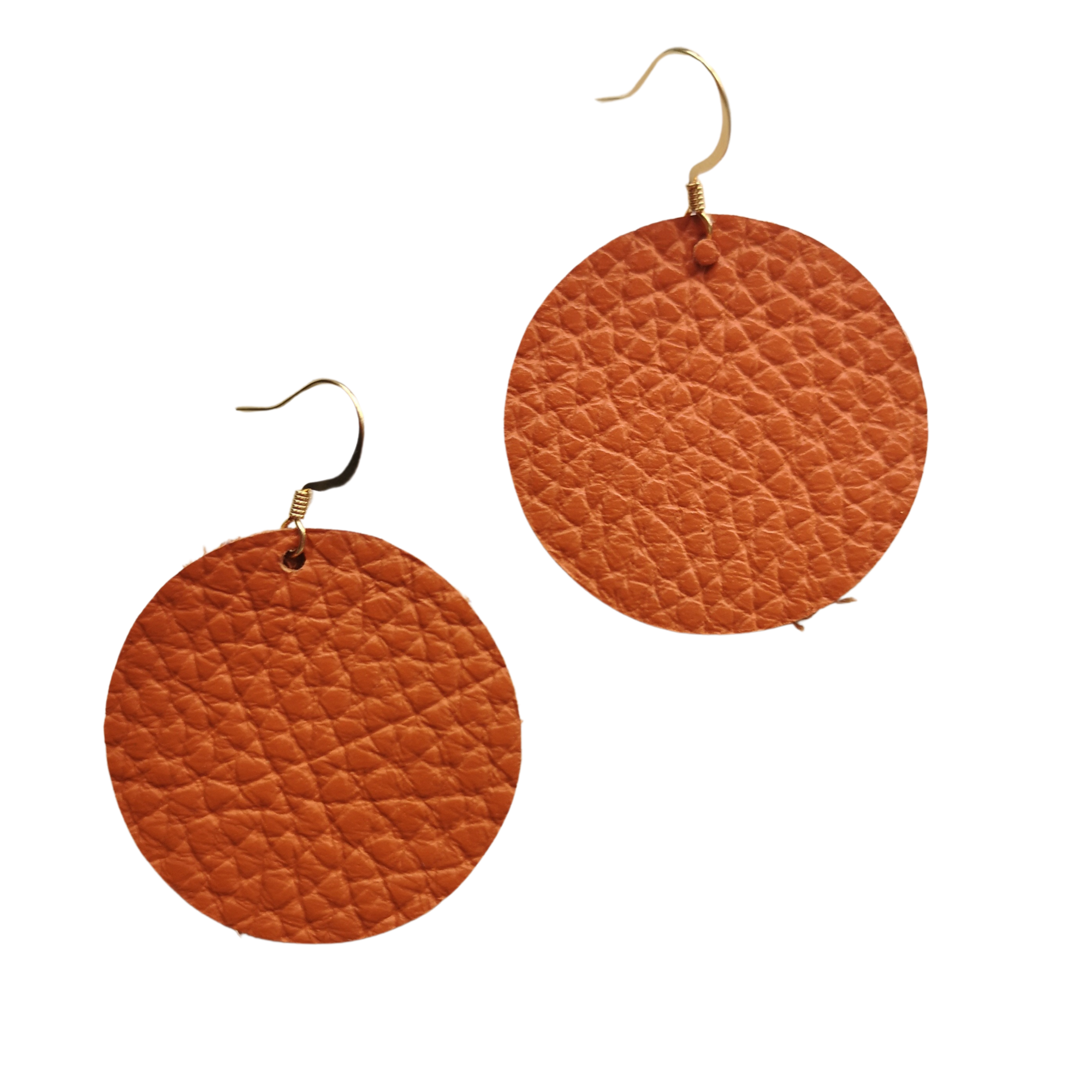 Grian leather earrings in burnt orange – circular lightweight earrings with gold hooks photographed on a plain white background