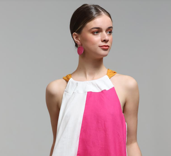 Model wearing Grian leather earrings in hot pink – handmade in Ireland

