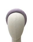 Lilac padded headband displayed on a neutral mannequin head against a white background
