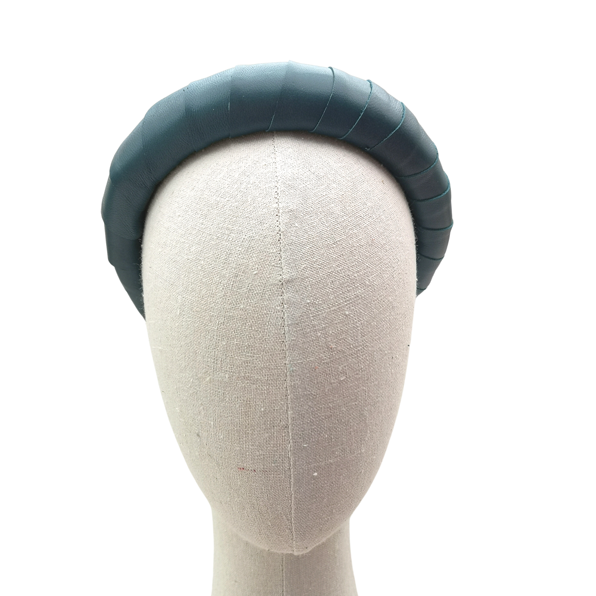 Deep teal padded satin headband displayed on a neutral mannequin head against a white background